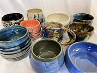 Top-down view of all ceramic bowls and mugs showing a variety of colors and glazes