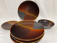 Overview of six stacked 11.5 inch dinner plates with one 8.5 inch salad plate and one 8 inch bowl visible.