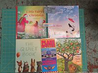Top view of all 5 books including Little Fairy's Christmas, Zen Shorts, The Quiet Book, Our Apple Tree, and Planes Spotter laminated guide.