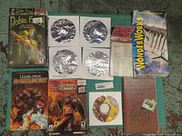 Photo showing multiple video game boxes, manuals, CDs, and guides in the lot laid out on a surface to display contents.