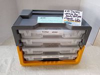 Closed view of the black and yellow storage case with four translucent drawers labeled with jewellery component categories