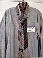 Men's John Weitz shirt with 4 neckties draped on hanger and 1 belt hooked over top.