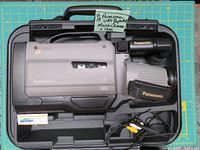 Panasonic VHS Reporter AG-188P movie camera in carrying case with battery and AV cable visible.
