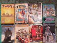 Photo showing eight vintage game manuals and guides including Stronghold Crusader with CD, Pharaoh, Zeus, 12 O' Clock High, Patrician II, Medieval Viking Invasion, Grand Ages Rome.
