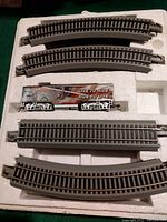 Curved and straight track pieces with Harley Davidson themed coal car.
