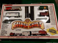 Boxed Bachmann Silver Chief train set showing locomotive, three cars, oval track and transformer in original packaging