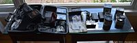 Overview photo of the open carrying case with JVC camera, lenses, cables, user manual, and other accessories laid out on a table.
