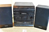 Full view of Panasonic stereo system with turntable on top and two speakers