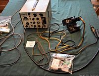 Complete view of Pace Incorporated soldering and rotary station main unit, foot pedal control, soldering iron in stand, and wiring.