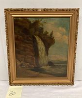 Front view of the antique oil painting showing the full waterfall landscape scene in its ornate gold frame.