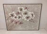 Frontal image of the oil painting showing white flowers on grayish beige background with black frame.