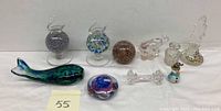 Full lot view showing all 10 glass pieces including perfume bottles, whale ornament, paperweight, animal figurines, and utensil rest.