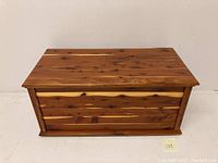 Front and top view of the vintage cedar chest storage box with natural wood grain visible.