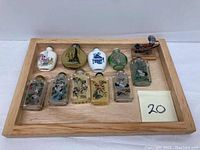 Full lot of ten vintage Chinese snuff bottles displayed on a wooden tray: 3 porcelain and 7 glass bottles with various hand-painted scenes and stoppers.
