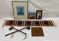 Full view of all items laid out on white background showing tapestry, art tiles, lithograph, wooden hatchet, war club, and leather panel with Chief's head.