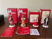 Four Bunnykins figurines displayed with their original red boxes and accompanying booklets.