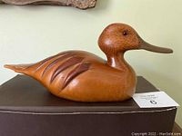 Side angle view of the wooden Pintail Hen showing the full body, carved and painted feathers, and signature style.
