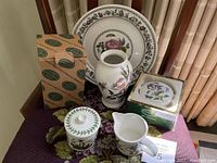 Photo showing all five pieces on a table including a large plate, vase, lidded jar, creamer, and green gift box for trinket dish, with two original boxes visible in background.