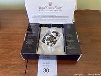 Cat paperweight figurine in original black satin box with certificate above.