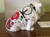 Side view of white bulldog figurine showing red and black London graphics