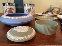 Photo showing porcelain items including Wedgwood jasperware pieces, Noritake jar, and Royal Worcester ashtray.