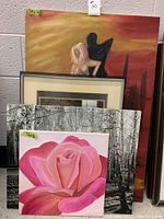 Five art pieces stacked: large warm painting with child and dog, framed art print in front, two black and white birch tree prints behind, and a 16x16 pink rose painting in front center