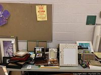Wide shot of various picture frames on a table, showing multiple sizes and styles.