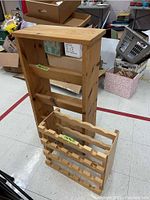Wooden bookshelf and wooden wine rack stacked, visible shelves and bottle holders.