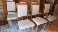 Front view of six chairs arranged in two rows on tiled floor.