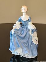 Front view showing detailed decoration and facial features of the figurine.