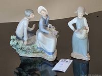Overview of both NAO figurines on reflective surface showing scale and details