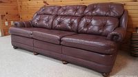 Full front view of three-seater leather sofa