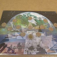 Full view of Canada Millennium 2000 coin set on illustrated card background.