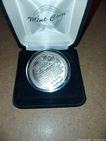 Close-up of the reverse side of the coin with Wayne Gretzky retirement details and logos, inside the presentation case.