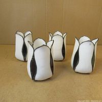 Four vintage white and red stained glass floral lampshades viewed from above and angled front, showing shape and condition.