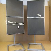 Front view of both speakers on stands with cables wrapped around modules