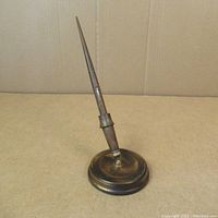 Full shot of Whal-Eversharp wood fountain pen upright in its round metal and wood stand.