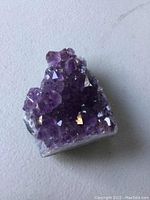 Close-up view of the natural amethyst crystal cluster showing the purple sparkling cubic crystals and natural matrix base, highlighting the size and texture.