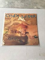 Front cover of Cyndi Lauper's True Colors vinyl LP in plastic sleeve showing album artwork with artist's name and album title.