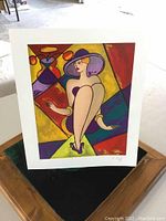 Full view of the serigraph print showing the seated woman with purple hat and geometric colorful background.