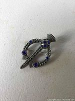 Silver-tone Scottish thistle brooch displayed on a white background.