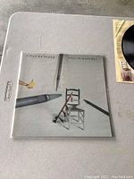 Front cover of the Pipes of Peace vinyl LP album showing the distinctive artwork with a chair and large pencils.