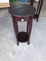 Front view of the plant stand showing drawer and lower shelf