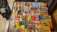 Wide view of 48 assorted comics arranged on floor