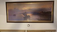 Framed print of R. Salvino's Fisherman's Farewell showing boat near shore at sunset, horizontal format in dark wood frame.
