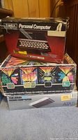 Stacked original boxes for Timex Sinclair 1000, Magnavox Odyssey2 and Atari 800XL