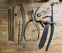 Photo showing all 11 vintage hand tools laid out on a wooden surface, showing wear and patina.