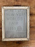 Full view of vintage framed textile featuring 1939 New York World's Fair design and text.