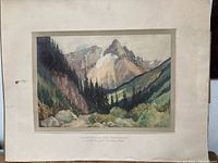 Full view of framed print with visible original matting and mountain landscape artwork.