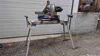 Front view of Bosch miter saw mounted on folding stand